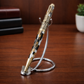Luxury striped pen with gold accents on metal stand, wooden desk background, elegant design