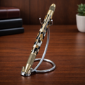 Luxury striped pen with gold accents on a metal stand, displayed on wooden desk