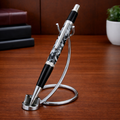 Luxury black and silver marble pen on modern chrome stand, wooden desk background