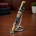 Luxury blue marbled pen with gold accents on chrome stand, desk background