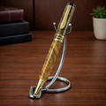 Luxury wood grain pen with gold accents on a metal stand, desk background, office decor
