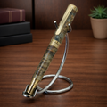 Luxury marbled fountain pen with gold accents on metal stand, wooden desk background