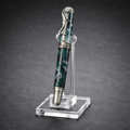 Luxury marbled fountain pen with silver golfer detail on cap, displayed on acrylic stand